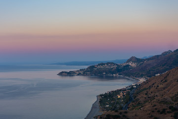 Fototapeta na wymiar Taormina Bay at dawn seen from Forza D'Agrò