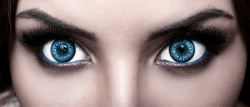close-up face of pretty girl with beautiful big blue eyes, big eyelashes and eyebrows in fantasy style