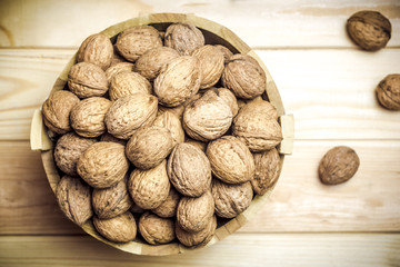 Walnuts in a wooden bucket.