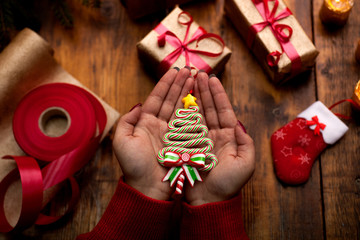 Hands of woman decorating Christmas gifts and decorations