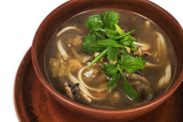Soup with mushrooms and spaghetti close-up