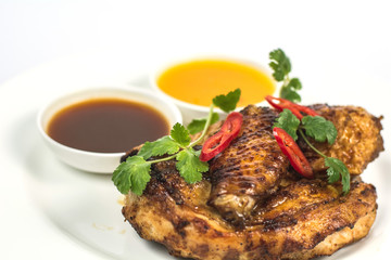 Baked chicken with herbs and sauce close-up