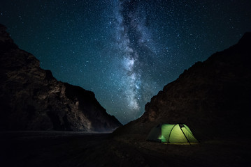 night rocky ravine, starry sky with bright milky way. a little camping - 180184090