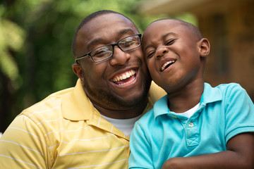 Father hugging his his son.