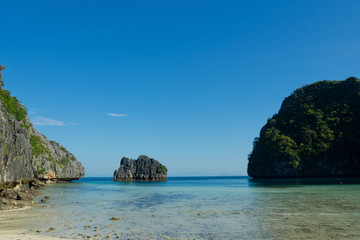 Obraz premium beautiful beach and sea with mountain background. Clear sea. Summer time. Relax on holidays. Travel