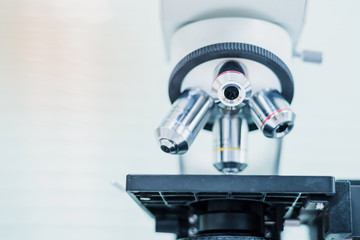Close up and soft focus of objective lens microscope in laboratory.Blue tone.