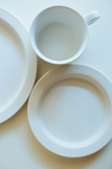 White plate and cup on white background