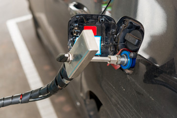 The car filling gas in a gas station.