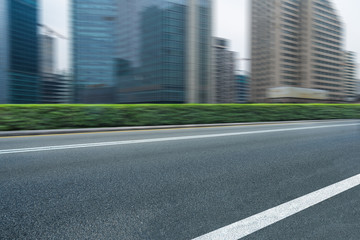 city empty traffic road with cityscape in background.