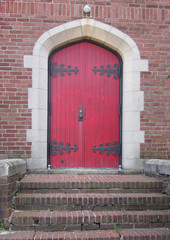 brick steps leading to red door
