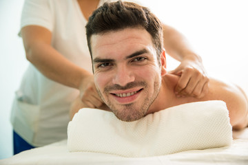 Happy Latin man getting a massage