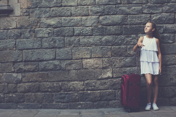 girl in white with travelling bag