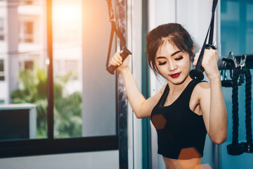 Obraz premium Asian woman exercising in the gym, Young woman workout in fitness for her healthy and office girl lifestyle.