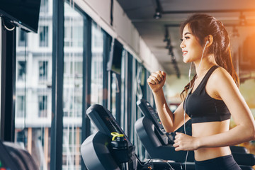 Fototapeta na wymiar Asian woman exercising in the gym, Young woman workout in fitness for her healthy and office girl lifestyle.