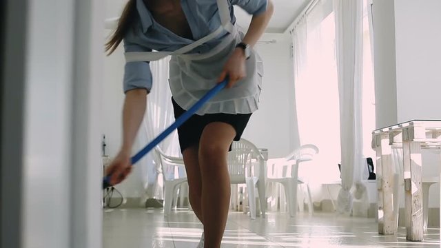 The maid washing the floor.