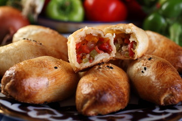 Samsa with vegetables and mutton or beef.Onion,bell pepper green and red,tomatoes, eggplant,carrot,hot pepper,cumin,salt to taste.Uzbek cuisine.Selective focus.