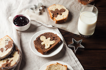 chocolate and vanilla snack cakes and a glass of milk on a wooden table