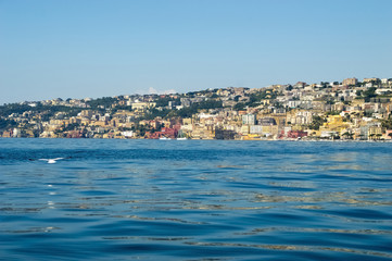 Fototapeta na wymiar View from the sea of Posillipo hill, Naples and the blue waters of the Gulf of Naples