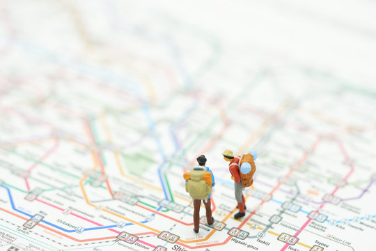 Miniature 2 people stand on a map of the subway lines in Japan. as background travel concept with copy space.