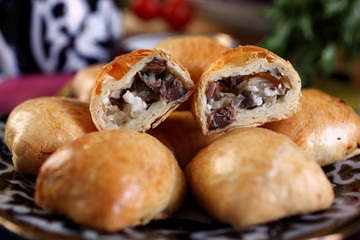 Samsa-Buttons.Finely chopped meat and fat lamb,onion,salt to taste.Baked in the oven.The table is supplied pre-sprinkle with pepper and vinegar.Uzbek cuisine.Selective focus.