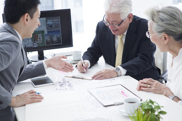 An old couple signing a contract gladly