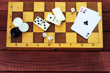 Various board games chess board, playing cards, dominoes. Hobby. Metaphor for games and gambling.
