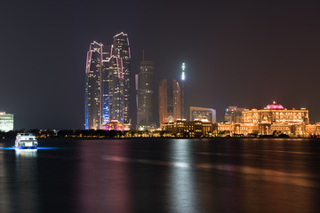 Fototapeta na wymiar Abu Dhabi buildings skyline from the sea at night