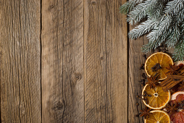 Christmas composition.Spruce branches with dried grapefruit and orange on old wooden table.
