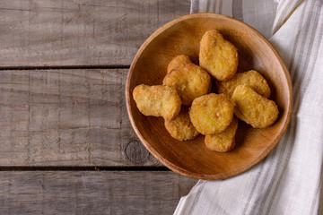 Chicken nuggets on wooden plate