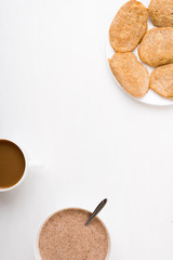 Fritters, coffee and flax-seed porridge on white