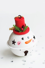 Obraz na płótnie Canvas Christmas and New Year background with Snowman decorative ball for Christmas tree. Holiday background with stars confetti.