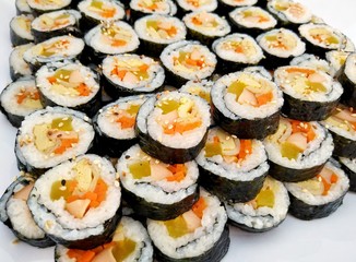 Kimbap or gimbap seaweed rice rolls on white background, Korean food
