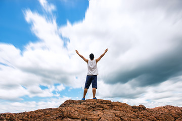 Asian handsome man on the top of mountain,sky radian effect