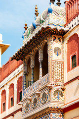 Beautiful balcony on Jaipur City Palace, Rajasthan, India. Part of decor of Maharaja Residence in Jaipur. Old Indian architecture with carving and ornament.