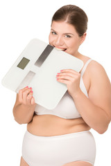 overweight woman biting scales