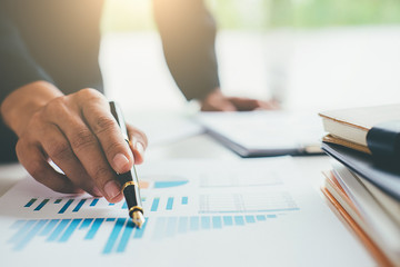 Business concept. Business people discussing the charts and graphs showing the results of their successful teamwork.