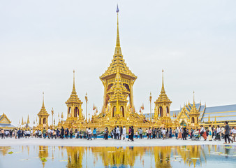 Naklejka premium Visitors tour around The Royal Crematorium for His Late Majesty King Bhumibol Adulyadej, Rama IX. Royal Cremation Exhibition is at Sanam Luang and remains open until Nov 30.
