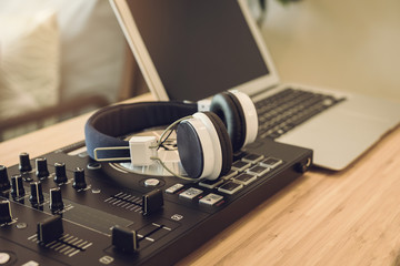Fototapeta na wymiar headphones with sound mixer console in home recording studio