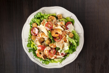 Overhead photo of shrimp Caesar salad with copyspace