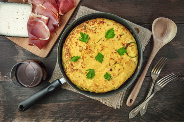 Spanish tortilla in tortillera, with wine, jamon, and cheese