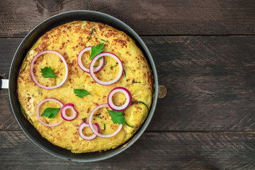 Spanish tortilla in tortillera with copy space, top view