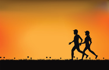 Silhouettes of couple runners with beautiful sky at sunset