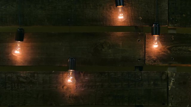 Bulbs hanging on wooden background