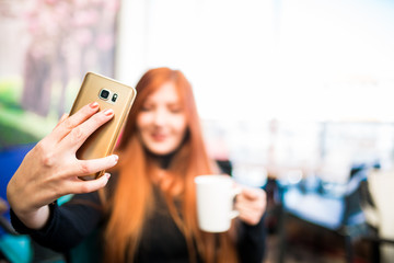 Beautiful girl drinking coffee at the coffee shop