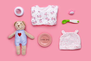 Cute toddler (girl) accessories on a pink background shot knolling style.