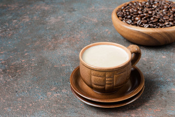 Coffee espresso in small brown clay cups and coffee fried grains on a dark background with copy space