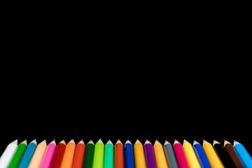 Soft focus of different colored pencils set for back to school art or design creativity concept on black background