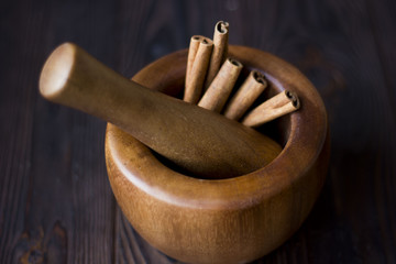 mortar with pestle and cinnamon