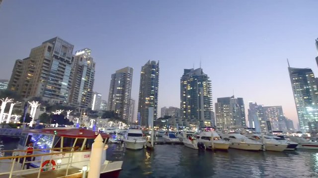 DUBAI - DECEMBER 2016: Dubai Marina at sunset. Dubai attracts 20 million tourists annually.