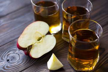 cut red Apple with Apple juice on a wooden table